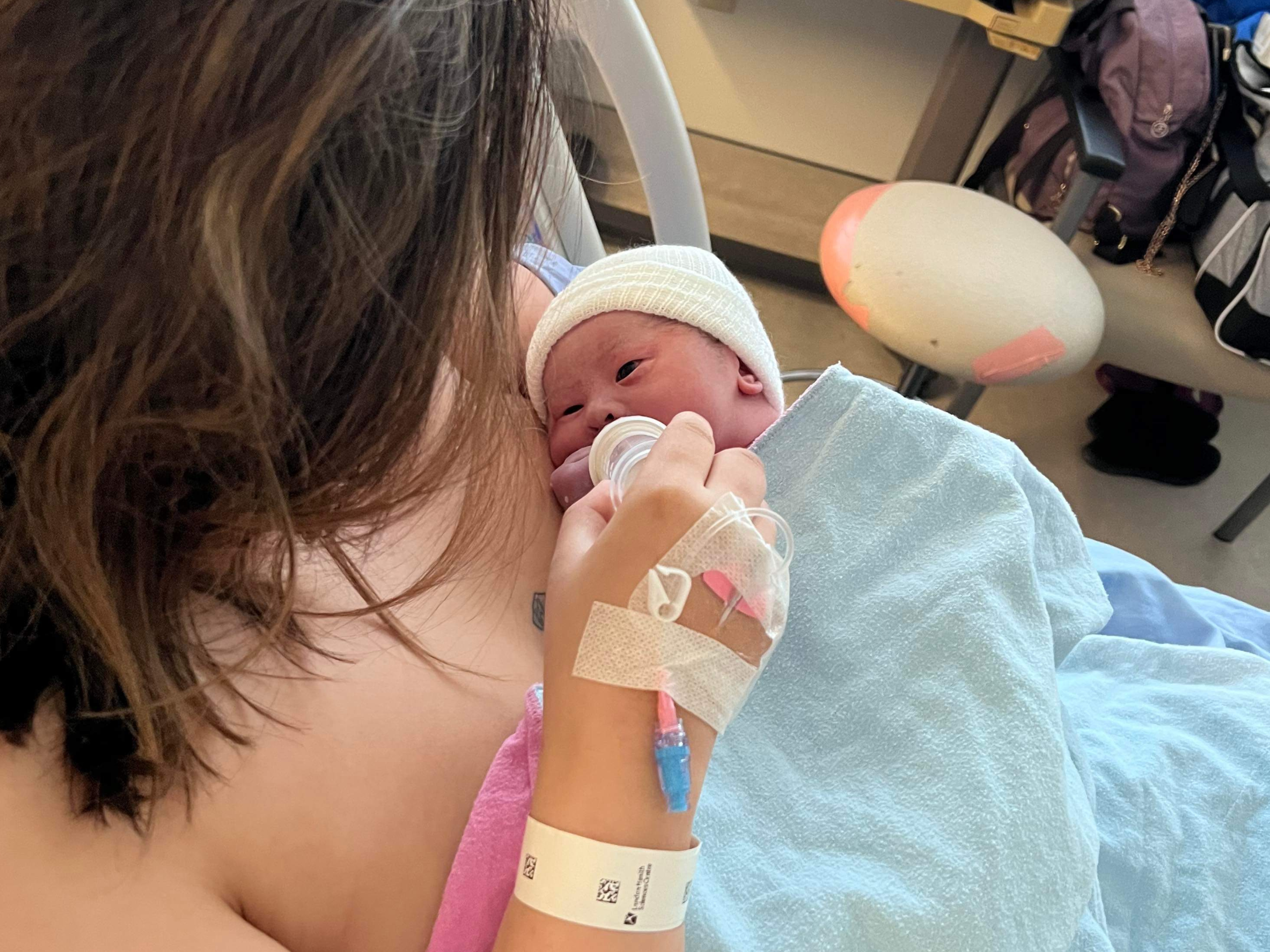 Jocelyn feeding her newborn son in a hospital