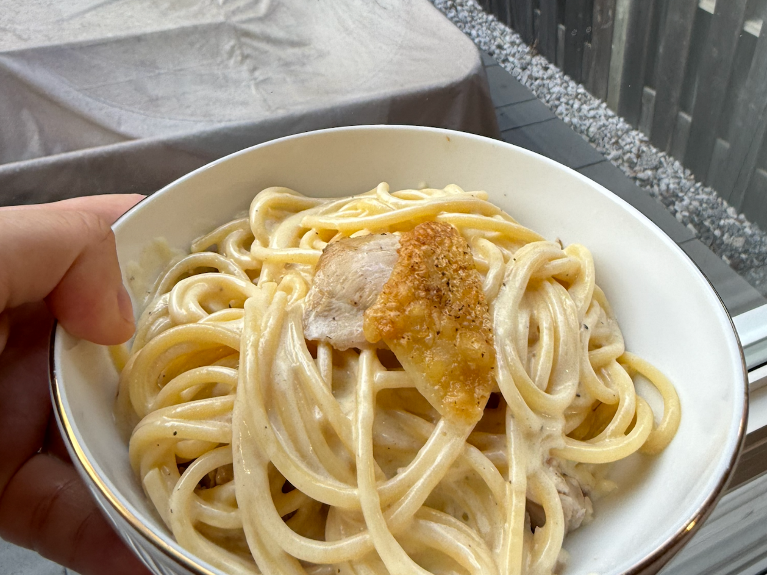 Chicken alfredo in gold rimmed bowl