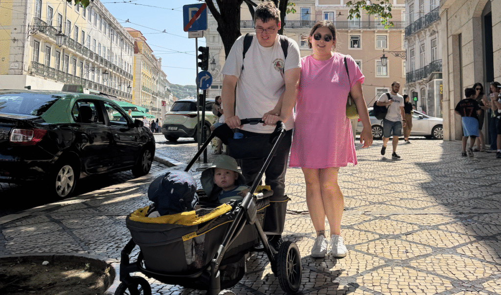 Family walking, kids in a stroller in Portugal